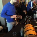 a group of people standing around a table with wine glasses