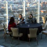 a group of people sitting at a table in front of a building